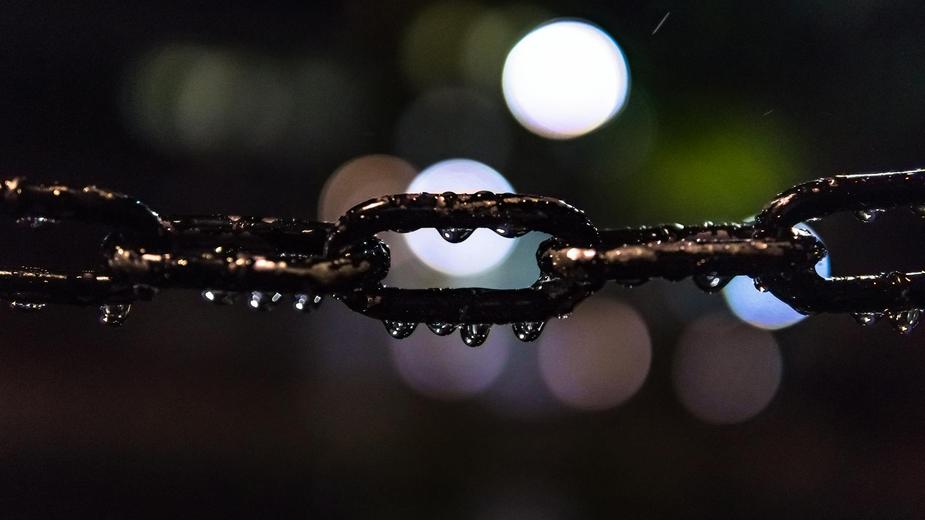 selective focus photo of black metal chain