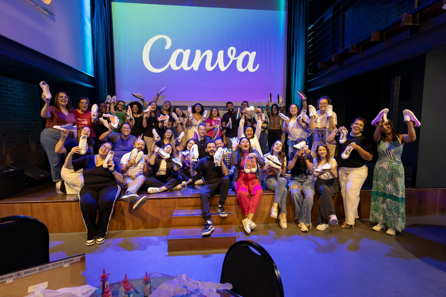 group holding customized shoes at canva event